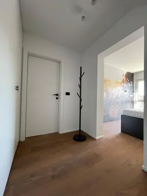 a bedroom with white walls and a bed and a window at Lanina Estate in Spodnje Hoče