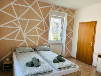 a bedroom with a bed with two pillows at Spacious & Calm Guesthouse in Ljubljana in Ljubljana