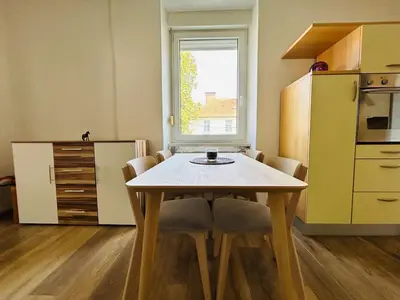 a kitchen with a table and chairs in a room at Spacious & Calm Guesthouse in Ljubljana in Ljubljana