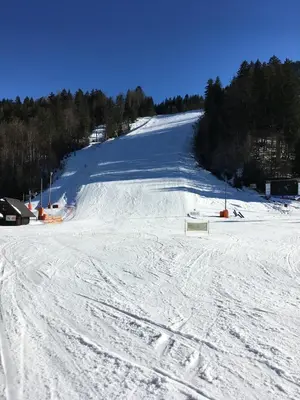 a snow covered ski slope with a ski lift at Mountain View House - Panoramic! in Gozd Martuljek