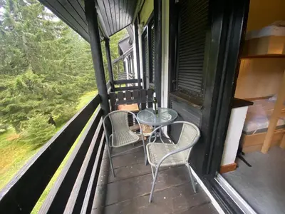 a balcony with a table and chairs on a train at Rogla Gaber Studio in Zreče