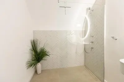 a bathroom with a shower with a plant in it at Valka in Ljubljana
