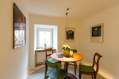 a room with a table and chairs and a window at Valka in Ljubljana
