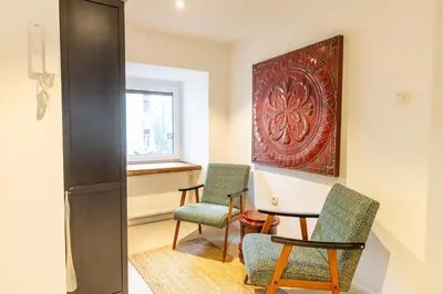 a room with two chairs and a painting on the wall at Valka in Ljubljana
