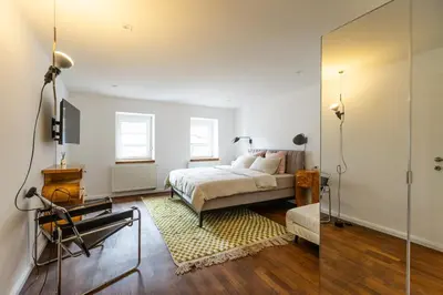 a bedroom with a bed and a mirror at Valka in Ljubljana