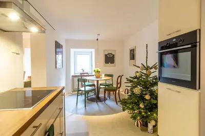 a kitchen with a christmas tree next to a table at Valka in Ljubljana