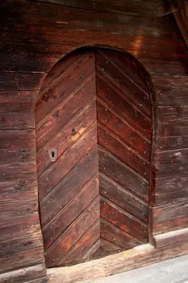 a large wooden door in a wooden cabin at Farmstay Hiša Pečovnik in Luče
