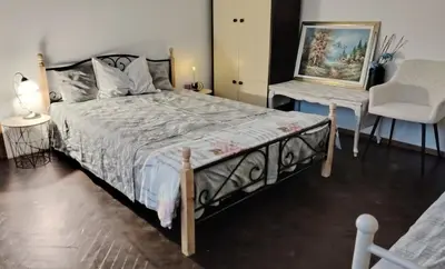 a bedroom with a bed and a table and a chair at Peace, homeliness and wonderful memories! in Maribor