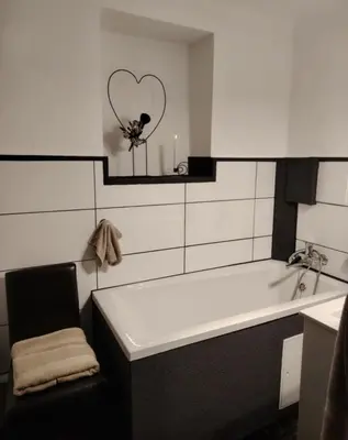 a bathroom with a bath tub and a heart mirror at Peace, homeliness and wonderful memories! in Maribor