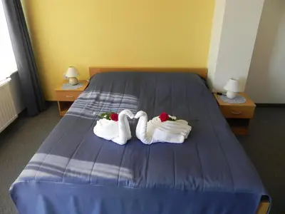 two towels on a bed in a hotel room at Motel Majolka in Ptuj