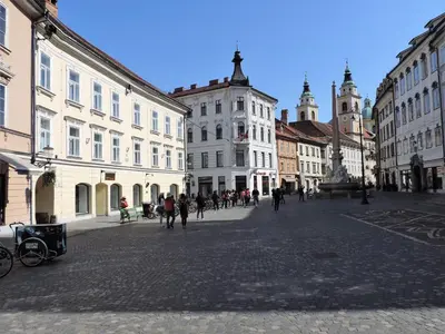 a group of people walking around a city street at Apartment Tara in Ljubljana