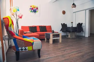 a living room with a couch and a chair at Apartment Tara in Ljubljana