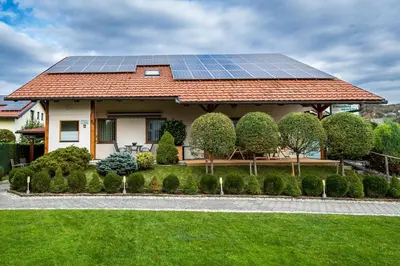a house with solar panels on the roof at Zimzeleni Apartments in Zreče