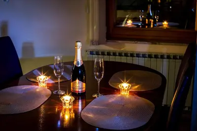 a bottle of wine sitting on a table with glasses at Zimzeleni Apartments in Zreče