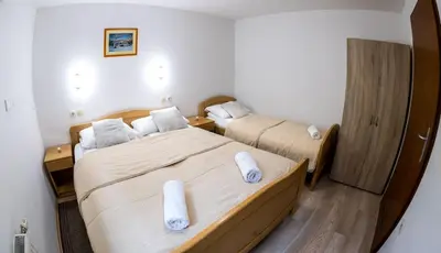 a bedroom with two beds with white pillows at Zimzeleni Apartments in Zreče