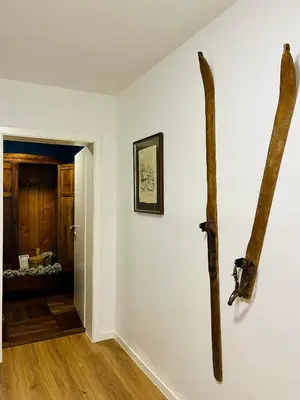 a room with a wall with two logs on a wall at Ian's Residence in Kranjska Gora