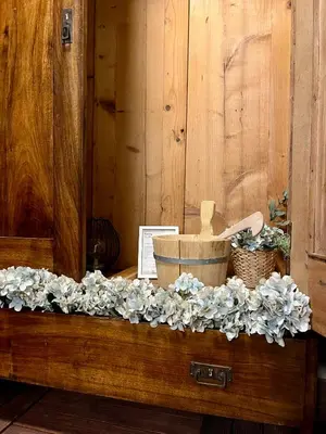 a wooden table with a flower arrangement on it at Ian's Residence in Kranjska Gora
