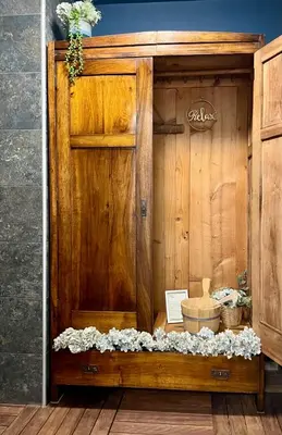 a wooden bath room with a wooden wall and a wooden floor at Ian's Residence in Kranjska Gora