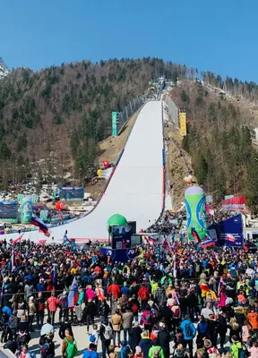a large crowd of people watching a ski slope at Ian's Residence in Kranjska Gora