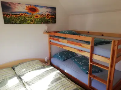 a bedroom with two bunk beds and a painting at Apartment Klas in Moravske Toplice