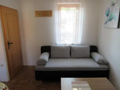 a living room with a couch and a window at Apartment Klas in Moravske Toplice