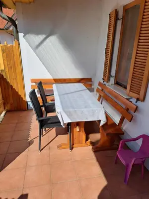 a table and chairs in a room with a table and chairs at Apartment Klas in Moravske Toplice