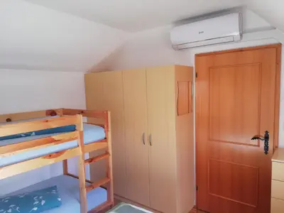 a room with a bunk bed and a door at Apartment Klas in Moravske Toplice
