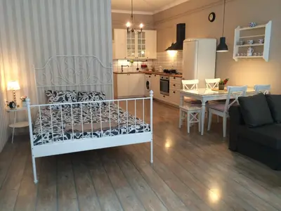 a living room and kitchen with a bed and a table at Julija & Filip Apartments in Ljubljana