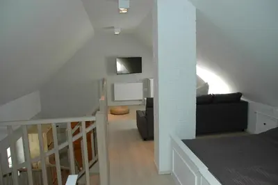 a room with a staircase and a living room at Country house Martinova Klet in Prosenjakovci