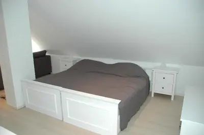 a bedroom with a white bed and two white night stands at Country house Martinova Klet in Prosenjakovci