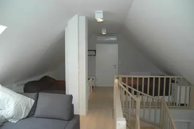 a living room with a couch and a staircase at Country house Martinova Klet in Prosenjakovci