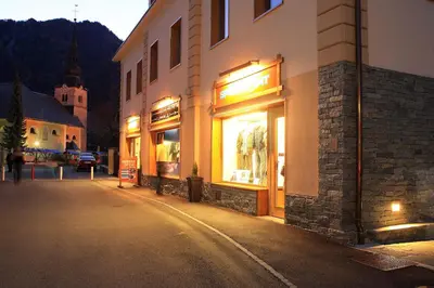 a building with lights in a street at night at Apartments Budinek in Kranjska Gora
