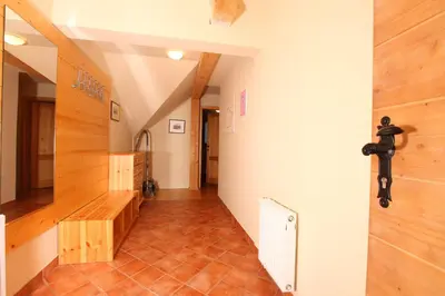 a hallway with a staircase with wooden floors and a hallway at Apartments Budinek in Kranjska Gora