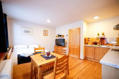 a living room with a couch and a table at Apartments Budinek in Kranjska Gora