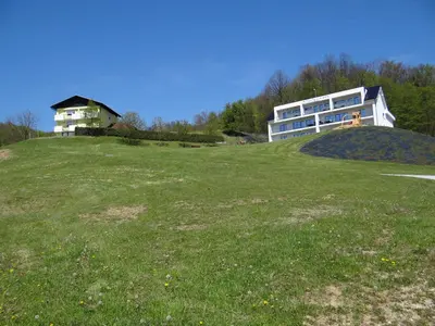 a large building on top of a grassy hill at Relax Center Olimian in Podčetrtek