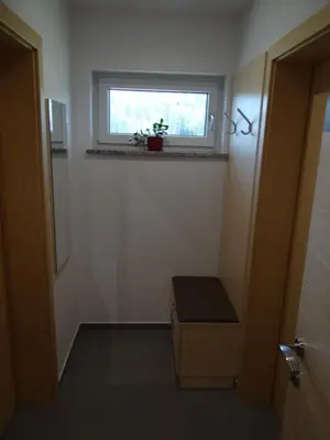 a small bathroom with a window and a plant on the window sill at Relax Center Olimian in Podčetrtek