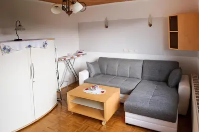 a living room with a couch and a table at Relax Center Olimian in Podčetrtek