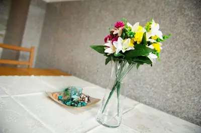 a vase filled with flowers sitting on a table at Relax Center Olimian in Podčetrtek