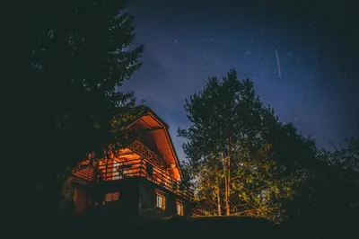 a cabin in the woods at night at Charming Chalet Rogla in Hudinja