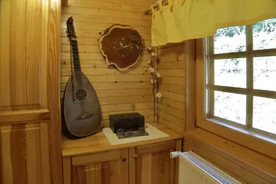 a guitar on the wall of a room with a window at Charming Chalet Rogla in Hudinja