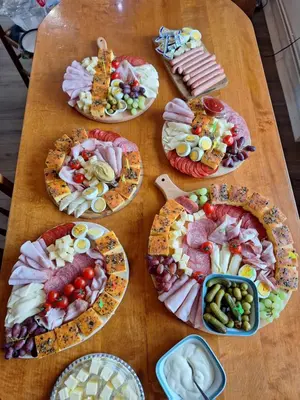 a table full of different types of food on plates at Mill House Apartment and Camping in Ljutomer