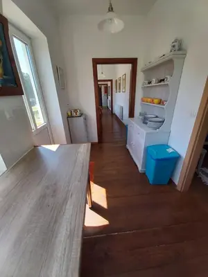 a kitchen with a wooden table in a room at Mill House Apartment and Camping in Ljutomer