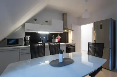 a kitchen with a table with a vase on it at Apartments Teja in Kranjska Gora