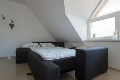 a small bedroom with a bed and a window at Apartments Teja in Kranjska Gora