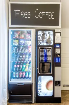 a free coffee vending machine with a free coffee sign at WH Apartments in Ljubljana