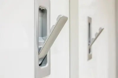 a mirror on a door with a handle at WH Apartments in Ljubljana