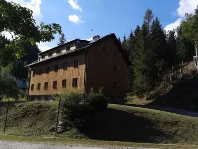 a building on the side of a road at APARTMENTS ROGLA JURGOVO - Ski in Ski out in Lukanja