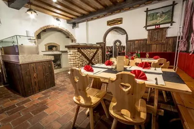 a kitchen with a large wooden table and chairs at Hiša Pr'Pristavc in Bohinj
