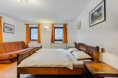 a bedroom with a bed and a couch at Apartments Mija in Krotica