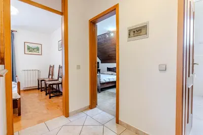 a hallway with a door leading to a bedroom at Apartments Mija in Krotica